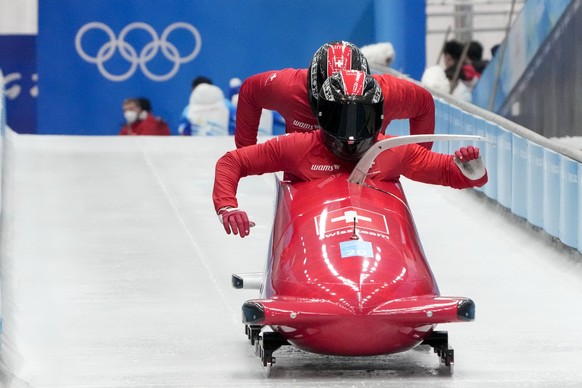 Michael Vogt, of Switzerland, drives his 2-man bobsled during a training heat at the 2022 Winter Olympics, Thursday, Feb. 10, 2022, in the Yanqing district of Beijing. (AP Photo/Mark Schiefelbein)