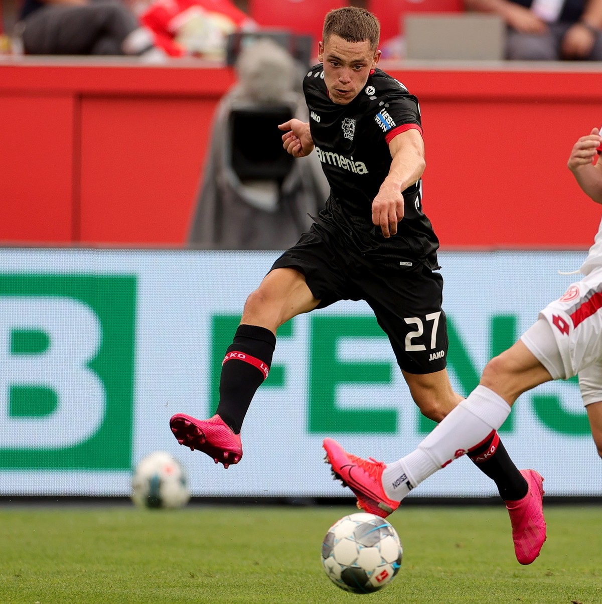 epa08512064 Leverkusen's Florian Wirtz (L) and Aaron (R) of Mainz in action during the German Bundesliga soccer match between Bayer 04 Leverkusen and FSV Mainz 05 in Leverkusen, Germany, 27 June  ...