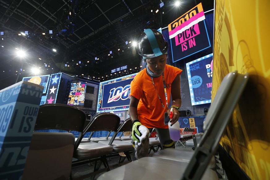 A worker cleans seating on the NFL stage ahead of the first-round NFL Draft, Wednesday, April 24, 2019, in Nashville, Tenn. The draft is scheduled to run Thursday through Saturday. (AP Photo/Steve Hel ...