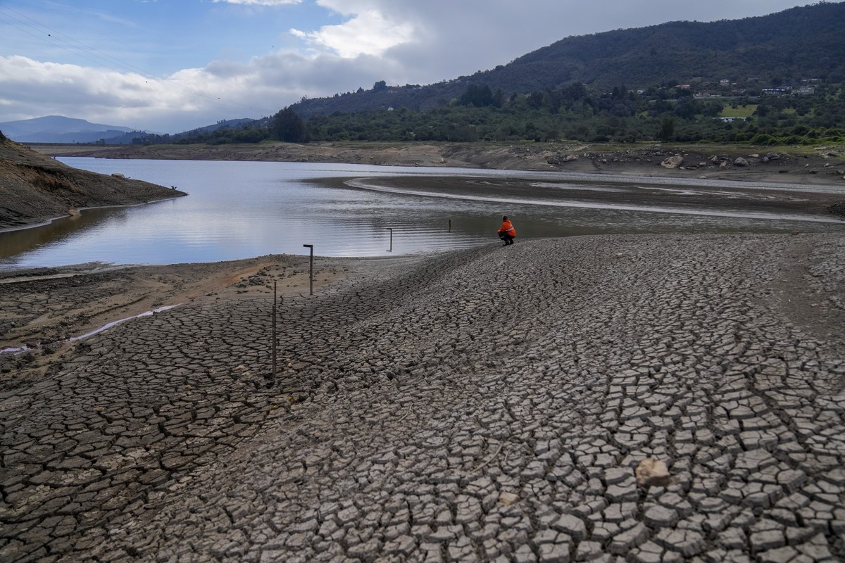 A worker of Bogota's water company monitors the level of the San Rafael reservoir, a source of drinking water for Bogota that is low due to the El Ni�o weather phenomenon, in La Calera on the out ...