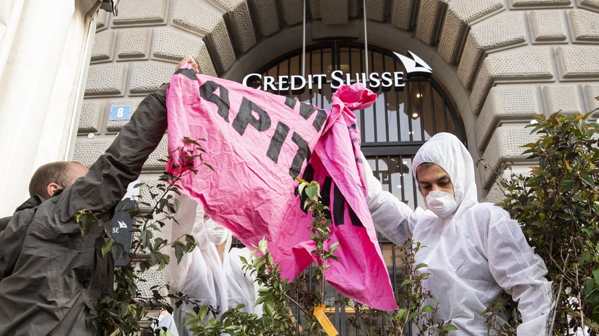 A group of climate activists from the Collective Climate Justice organization is blocking the entrance to the Swiss bank Credit Suisse on Paradeplatz in Zurich, Switzerland, Monday, July 8, 2019. The  ...
