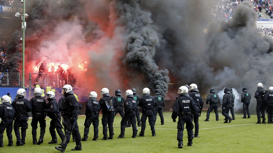 Hamburg fans throw fireworks when their team relegates for the first time in German Bundesliga history after the German Bundesliga soccer match between Hamburger SV and VfL Borussia Moenchengladbach i ...