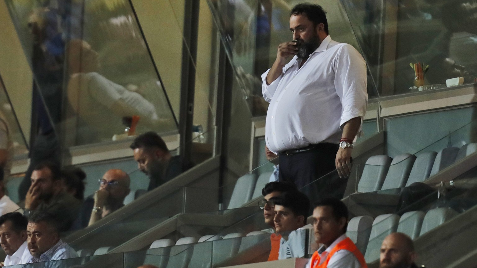 Olympiakos&#039;s soccer club chairman Vangelis Marinakis, pauses as he watches his team during the Champions League third qualifying round, first leg soccer match between Basaksehir and Olympiakos in ...