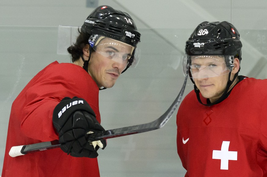 Switzerland&#039;s forward Roman Wick, left, and Switzerland&#039;s forward Damien Brunner, right, during a training session of the Swiss men&#039;s national ice hockey team at the XXII Winter Olympic ...