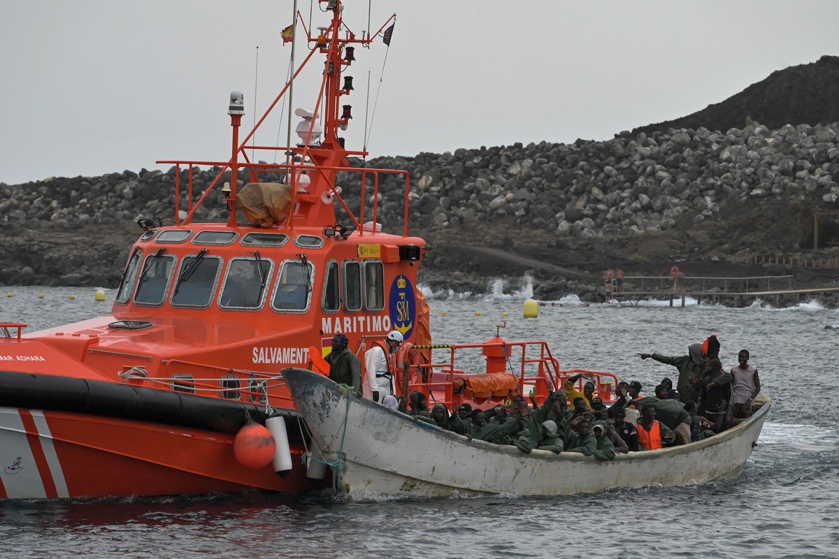 epa11567610 Migrants rescued from one of the boats that have reached waters near El Hierro, and transferred to the port of La Restinga, arrive to be treated by the emergency teams in the municipality  ...