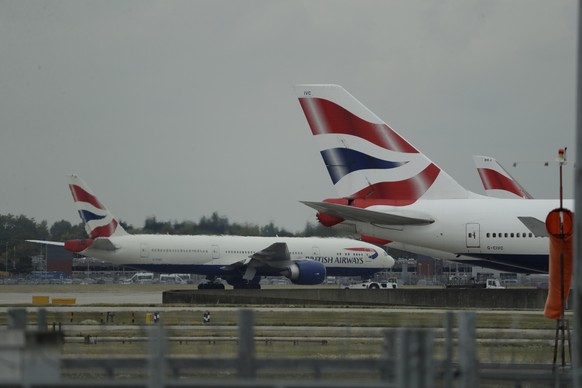 FILE - In this Monday, Sept. 9, 2019 file photo, a British Airways plane, at left, is towed past other planes sitting parked at Heathrow Airport in London. British Airways said Tuesday Nov. 17, 2020,  ...