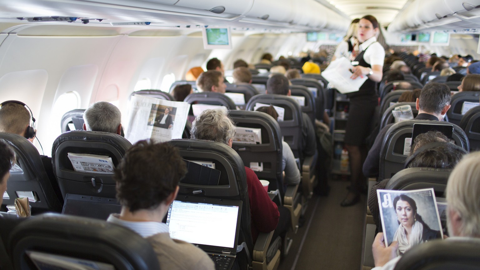 A flight attendant serves breakfast during the flight to Zurich, pictured on April 12, 2013, in an Airbus A319. The Airbus A319, an aircraft of Swiss International Air Lines, flies from Zurich to Oslo ...