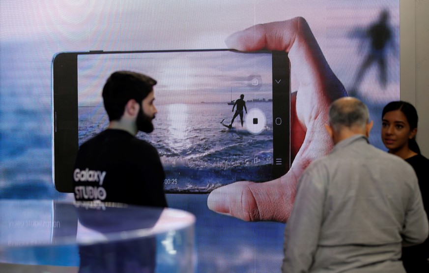 epa07490476 Visitor (C) inspects one of mobile innovation for Galaxy S10 at Galaxy Studio in Dubai, United Arab Emirates, 07 April 2019. Samsung Gulf electronics has brought back the Galaxy Studio to  ...