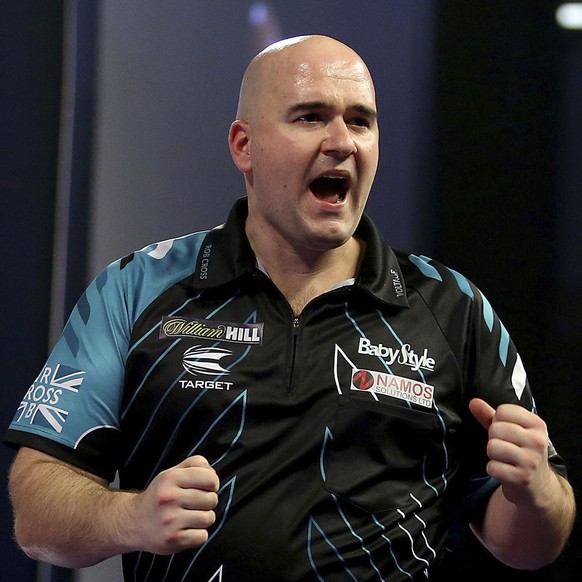Britain&#039;s Rob Cross celebrates after winning against Netherlands&#039; Michael van Gerwen during day fourteen of the World Darts Championship at Alexandra Palace in London, Saturday, Dec. 30, 201 ...