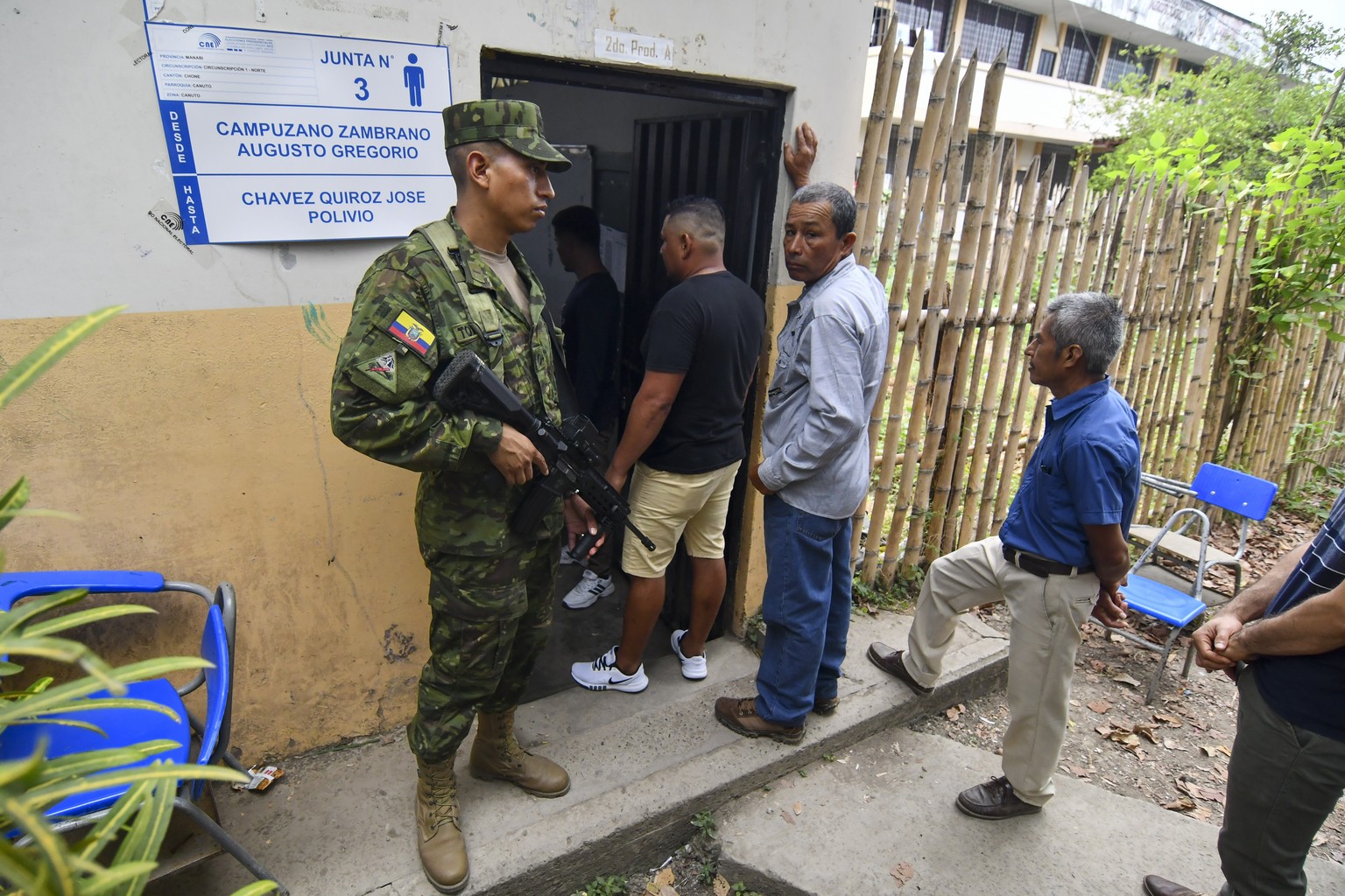 A soldier guards a polling station during a runoff presidential election in Canuto, Ecuador, Sunday, Oct. 15, 2023. (AP Photo/Ariel Ochoa)