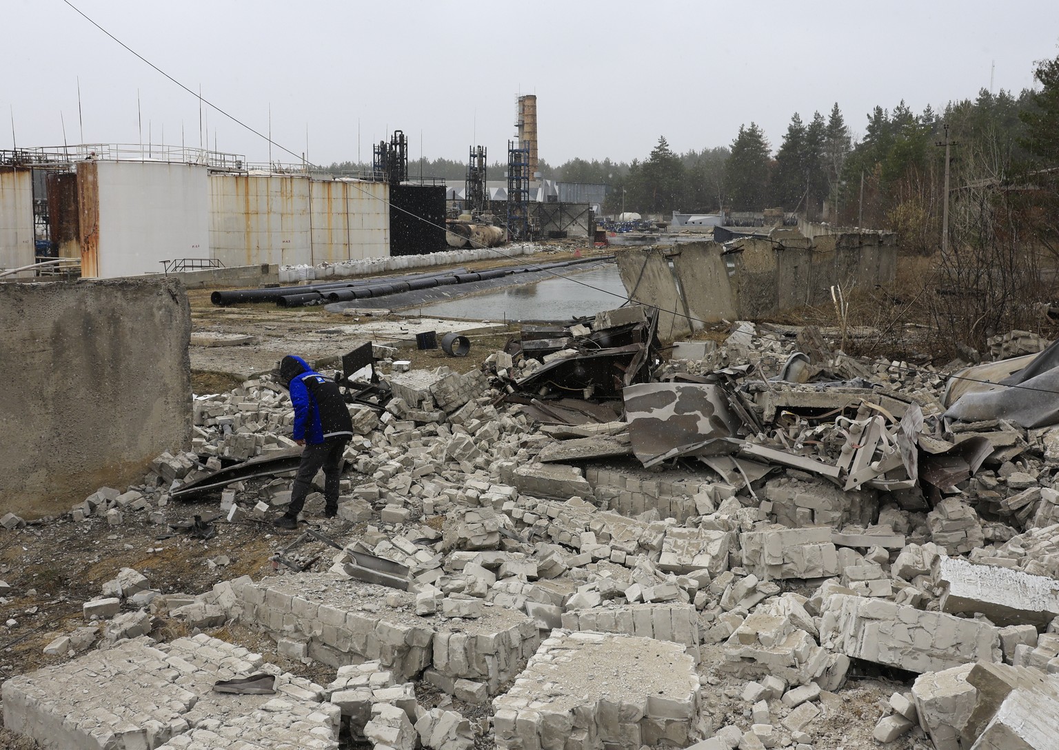 epa11971903 A worker inspects the damage at the AES Group private oil refinery the day after a Russian shock drone attack, in Merefa, Kharkiv region, Ukraine, 18 March 2025. Kharkiv investment and ind ...