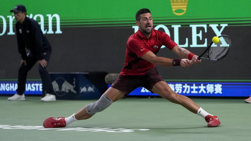 Novak Djokovic of Serbia plays a backhand return against Taylor Fritz of the United States during the men&#039;s singles semifinals match in the Shanghai Masters tennis tournament at Qizhong Forest Sp ...