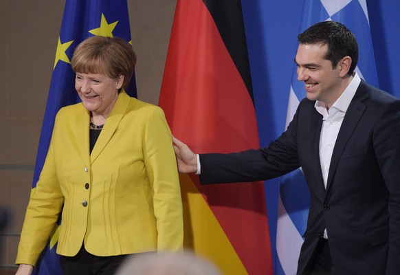 epa04676339 German Chancellor Angela Merkel (L) and Greek Prime Minister Alexis Tsipras (R) leave after a joint press conference on their previous talk in the Federal Chancellery in Berlin, Germany, 2 ...