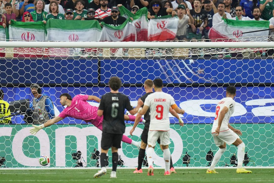 New Zealand goalkeeper Max Crocombe (1) fails to block a shot from Iran's Mohammad Mohebbi (8) during the World Cup Group G soccer match between Iran and New Zealand in Inglewood, Calif., near Lo ...