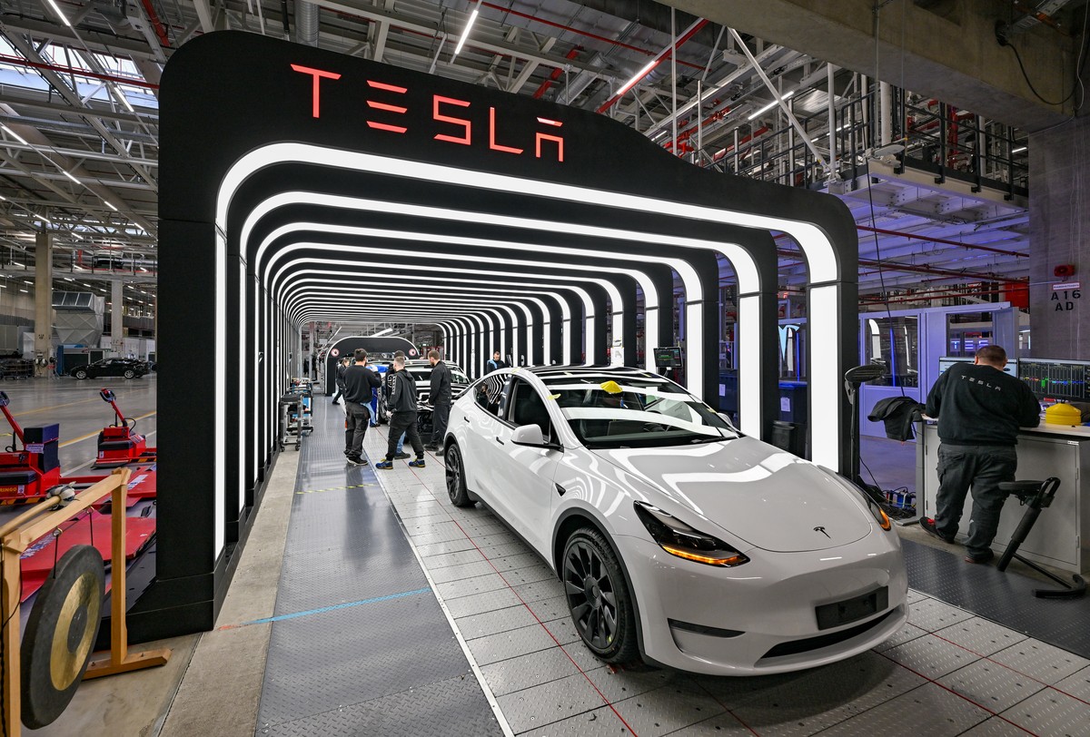 ARCHIV - 20.03.2023, Brandenburg, Gr�nheide: Mitarbeiter der Tesla Gigafactory Berlin Brandenburg arbeiten an der Endkontrolle der fertigen Elektrofahrzeuge vom Typ Model Y. Der US-Elektrofahrzeugbaue ...
