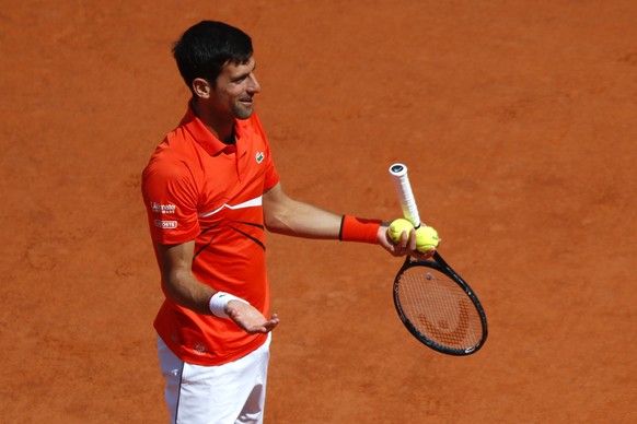 Serbia&#039;s Novak Djokovic reacts as he playts against Austria&#039;s Dominic Thiem during the men&#039;s semifinal match of the French Open tennis tournament at the Roland Garros stadium in Paris,  ...