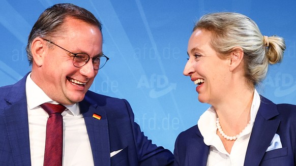 epa11620278 Alternative for Germany (AfD) right-wing political party co-chairman, Tino Chrupalla (L), and AfD deputy chairwoman, Alice Weidel (R), talk after an AfD party press conference in Berlin, 2 ...