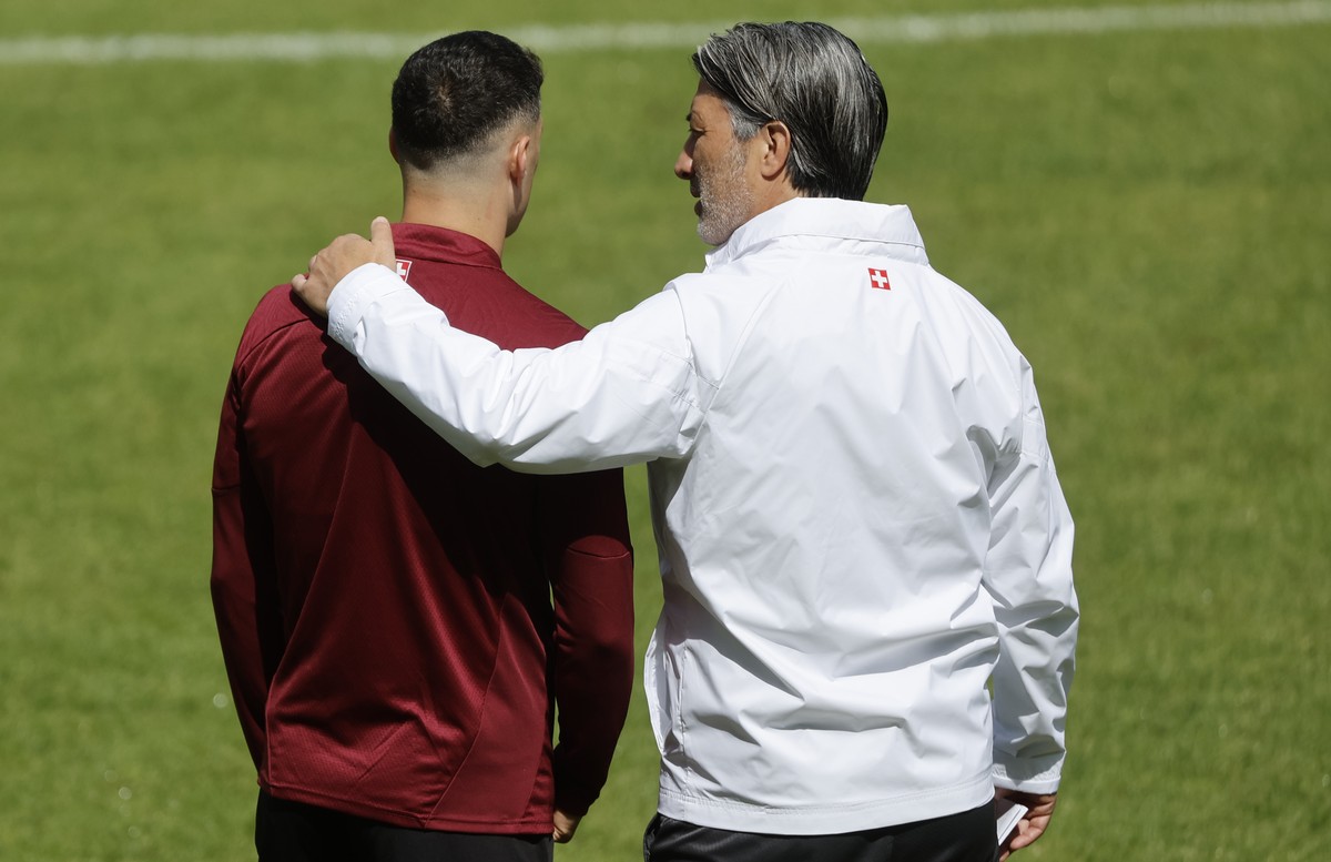 Switzerland's head coach Murat Yakin, right, talks to his captain Granit Xhaka during a training session at the "Stadion auf der Waldau" in Stuttgart, Germany, Friday, July 5, 2024. (KE ...