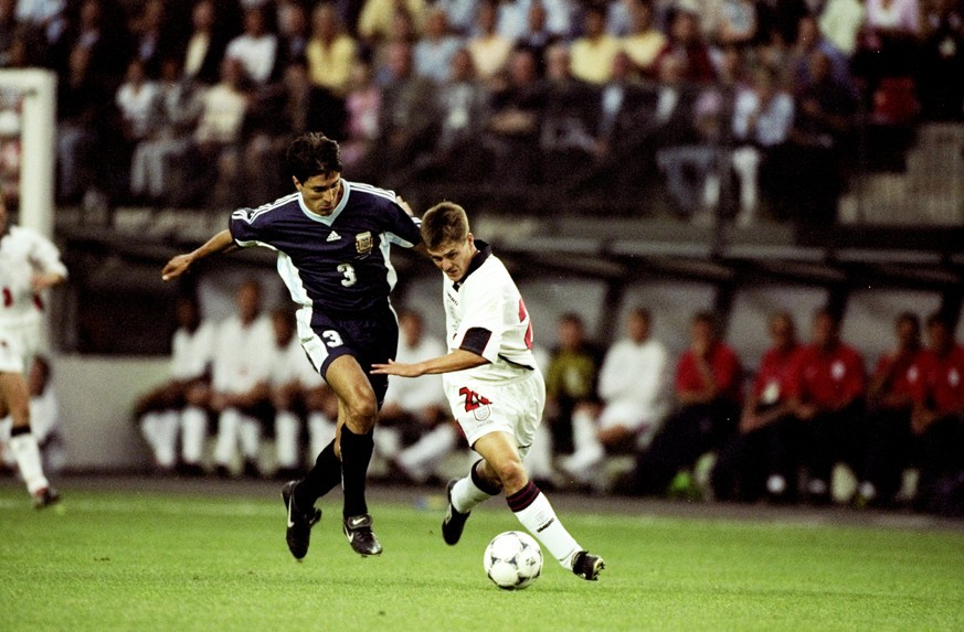 30 Jun 1998: Michael Owen of England shrugs off Jose Chamot of Argentina on his way to goal during the World Cup second round match at the Stade Geoffroy Guichard in St Etienne, France. England lost 4 ...