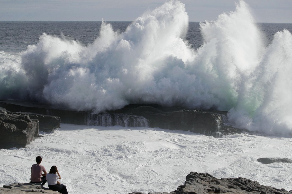A couple watches waves hitting a coast of Shirahara town, Wakayama prefecture, central Japan, Monday, Sept. 3, 2018. Powerful Typhoon Jebi is approaching Japan's Pacific coast and forecast to bri ...