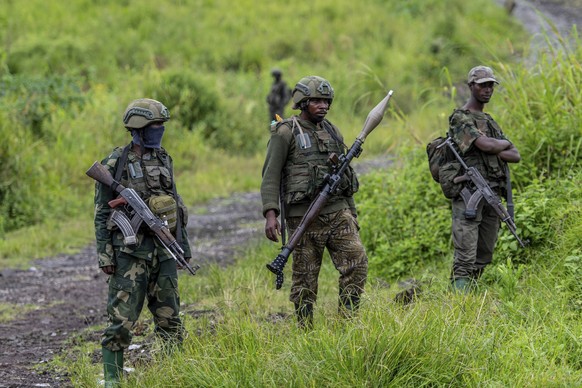 FILE - M23 rebels stand with their weapons in Kibumba, in the eastern of Democratic Republic of Congo, Dec. 23, 2022. (AP Photo/Moses Sawasawa, File)
Congo-Rebels-Peace-Agreement