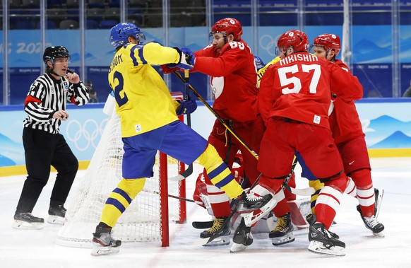 epa09769490 Nikita Nesterov (2-L) of Russia in action against Joakim Nordstrom of Sweden during Men&#039;s Ice Hockey semi final match between Sweden and Russian Olympic Comittee at the Beijing 2022 O ...
