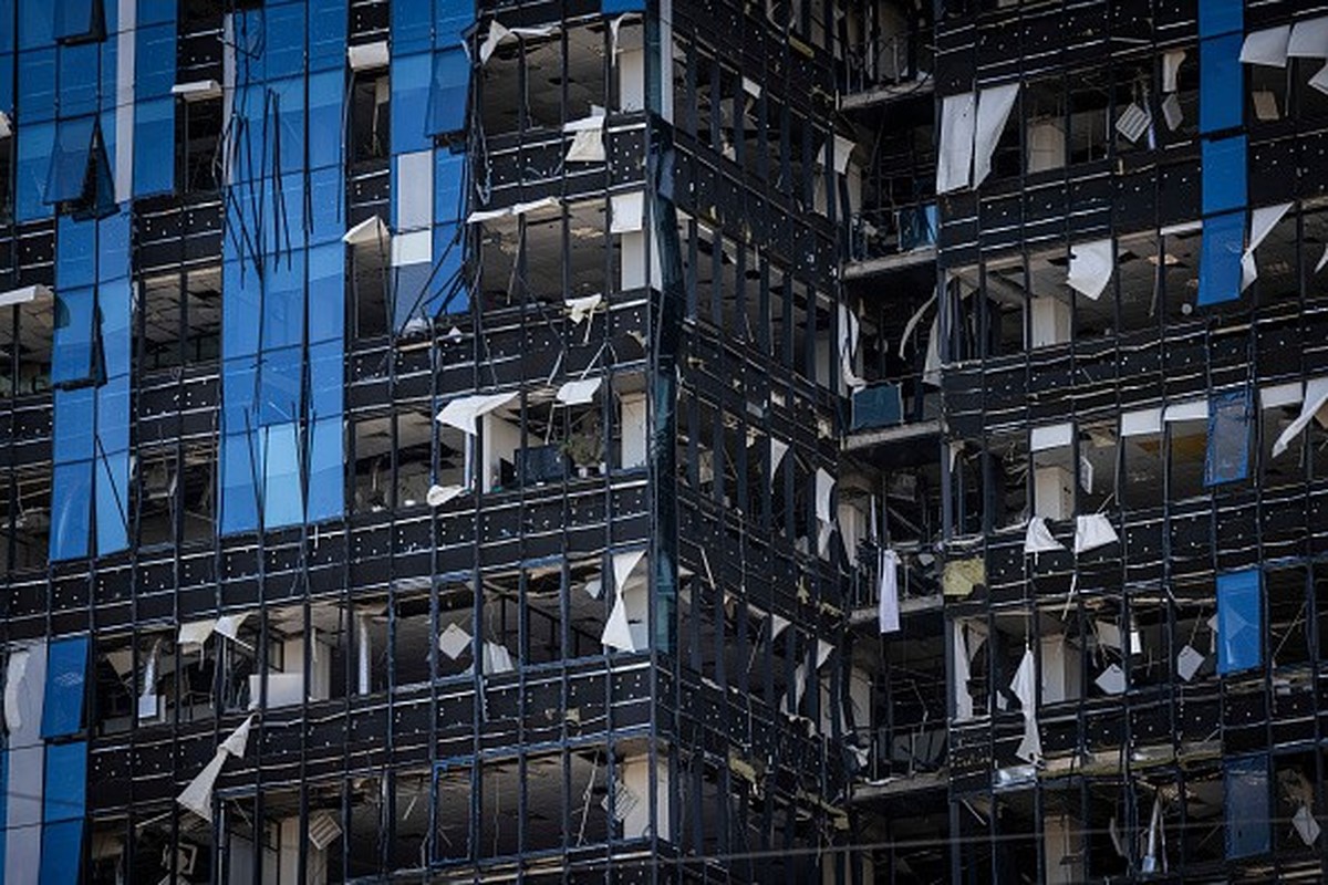 KYIV, UKRAINE - OCTOBER 10: A high-rise building stands badly damaged as emergency services personnel attend the site of a blast on October 10, 2022 in Kyiv, Ukraine. This morning's explosions, w ...
