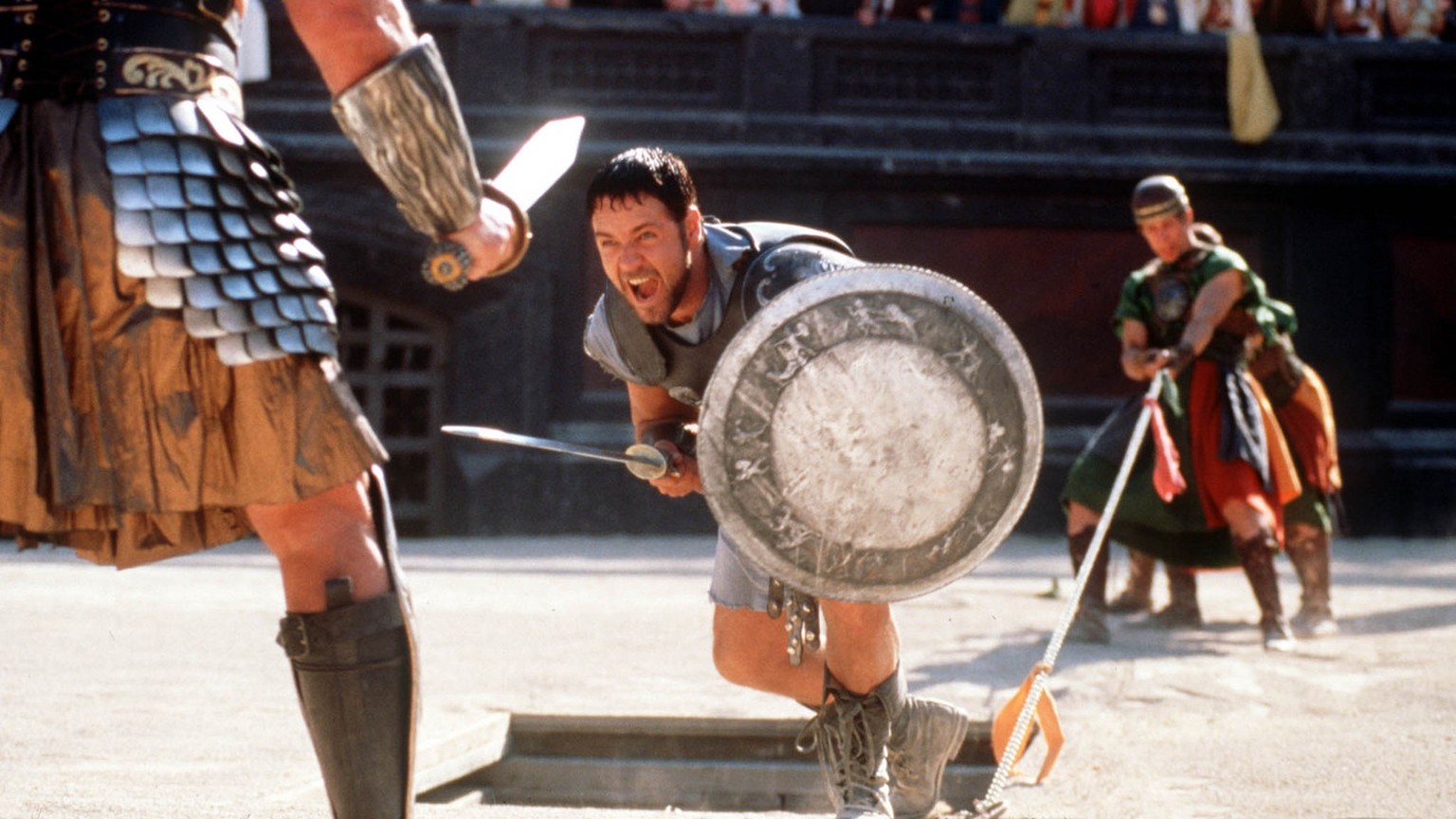 Russell Crowe center fights a gladiator in his role as Roman general Maximus, in this handout photo from Universal&#039;s film &quot;Gladiator,&quot; directed by Ridley Scott. Colleagues say the 36-ye ...