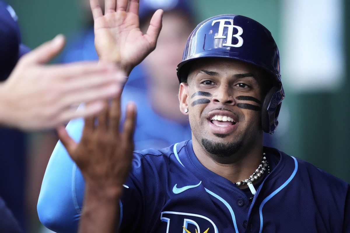 Tampa Bay Rays' Christopher Morel celebrates in the dugout after scoring on a bunt single by Jose Caballero during the second inning of a baseball game against the Kansas City Royals, Wednesday,  ...