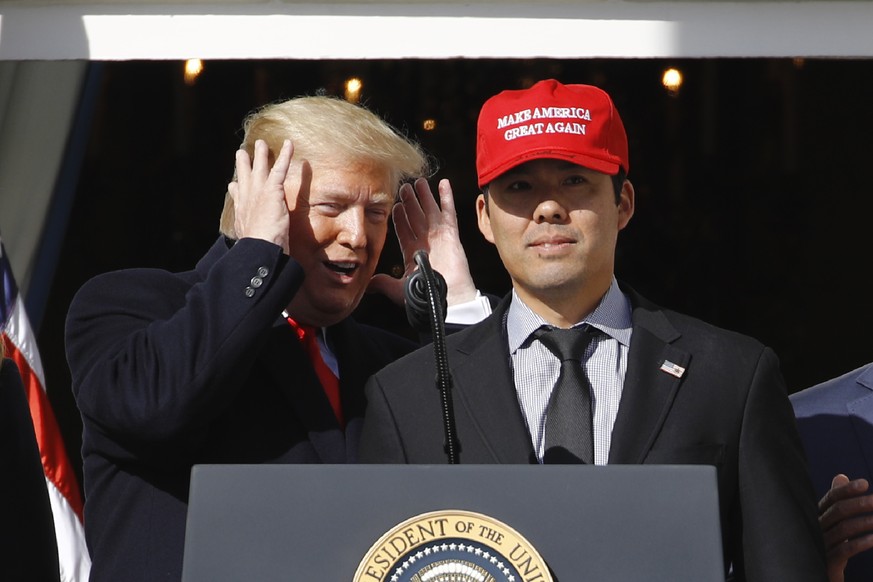 President Donald Trump reacts as Washington Nationals catcher Kurt Suzuki walks to a podium to speak during an event to honor the 2019 World Series champion Nationals baseball team at the White House, ...