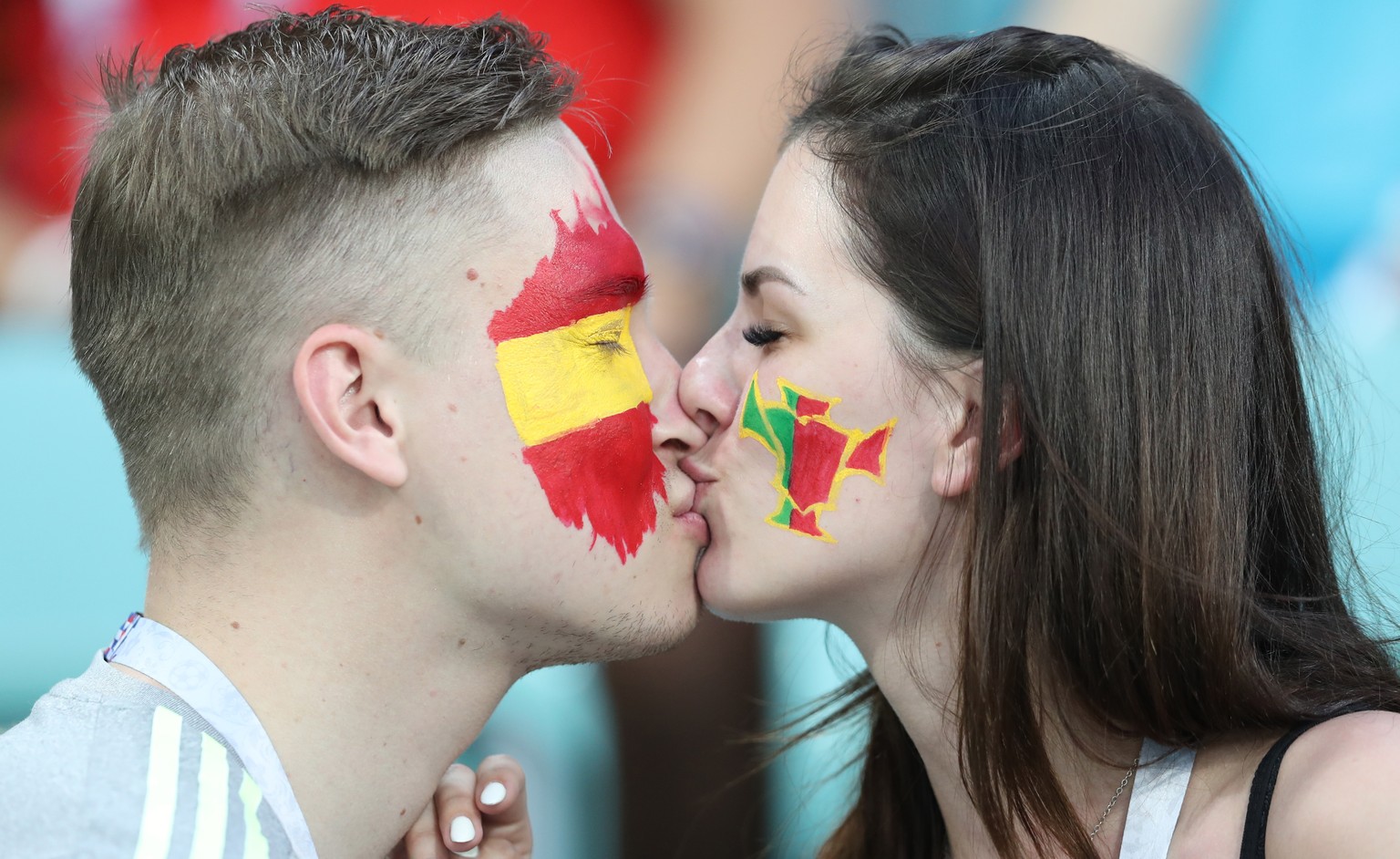 epa06810861 Soccer fans in Spanish and Portuguese colours kiss each other before the FIFA World Cup 2018 group B preliminary round soccer match between Portugal and Spain in Sochi, Russia, 15 June 201 ...