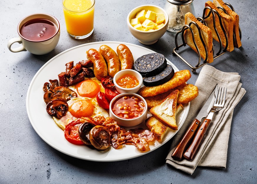 full english breakfast spiegelei wurst grillierte tomaten baked beans bohnen black pudding blutwurst pilz mushrooms hash brown toast bacon speck essen food kaffee tee orangensaft