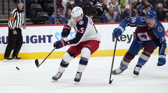 Columbus Blue Jackets left wing Gregory Hofmann, left, drives to the net for a shot next to Colorado Avalanche defenseman Kurtis MacDermid during the second period of an NHL hockey game Wednesday, Nov ...