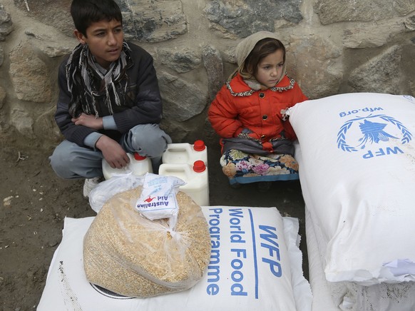 FILE - In this Jan. 24, 2017 file photo, children wait for transportation after receiving food donated by the World Food Program, in Kabul, Afghanistan. On Friday, Oct. 9, 2020 the WFP won the 2020 No ...