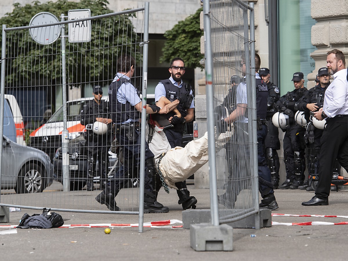 Schwerarbeit für die Staatsgewalt: Polizisten tragen eine Klimaaktivistin vom Eingang der Credit Suisse in Zürich weg.