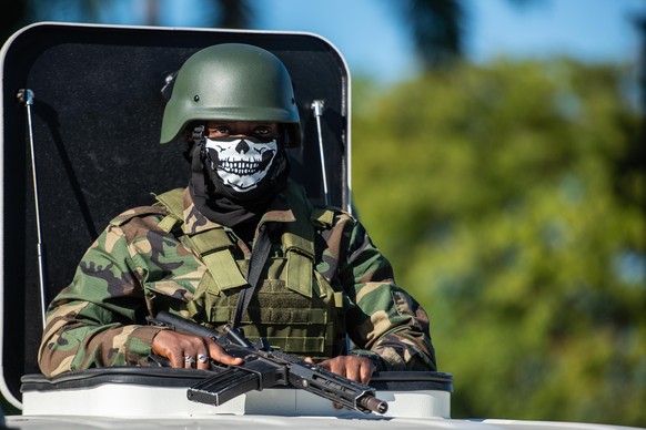 epa11052522 An armed soldier stands guard during the Independence Day ceremony on Champs Mars in Port-au-Prince, Haiti, January 1, 2024. Haiti, the first country in Latin America and the Caribbean to...
