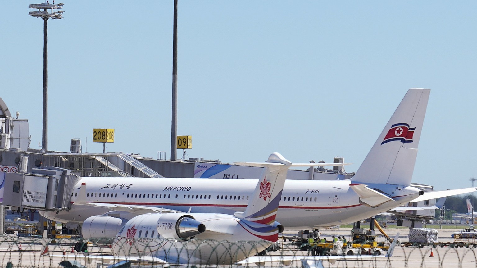 Ground crew work near an Air Koryo commercial plane on the tarmac at the Beijing Capital International Airport in Beijing, Tuesday, Aug. 22, 2023. A North Korean commercial flight has landed in Beijin ...