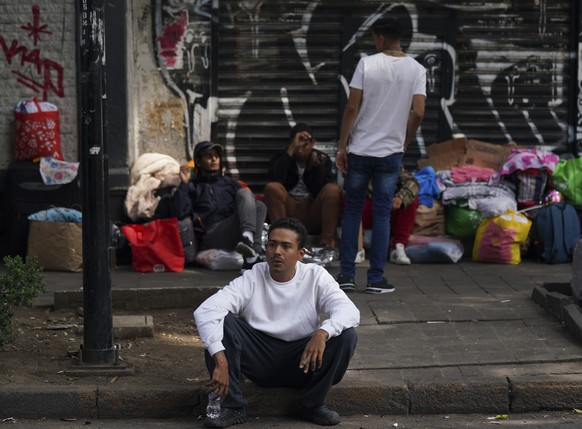 Venezuelan migrants seek assistance outside the Mexican Commission for Refugee Aid in Mexico City, Thursday, Oct. 20, 2022. These Venezuelan migrants were returned to Mexico by U.S. immigration author ...