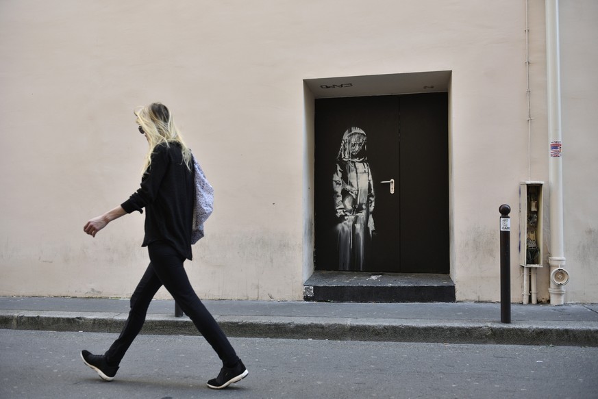 epa06841325 A recent artwork believed to be attributed to Banksy is of a woman veiled in mourning next to the Bataclan concert venue in Paris, France, 26 June 2018. Several artworks attributed to the  ...