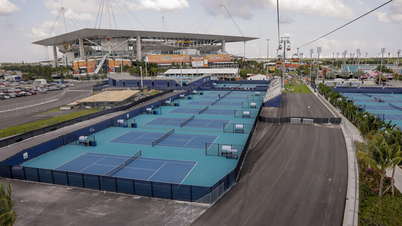 epa09861145 An overhead view from a gondola ride of the Miami Open tennis tournament and Formula One car racing track under construction at Hard Rock Stadium in Miami Gardens, Florida, USA, 30 March 2 ...