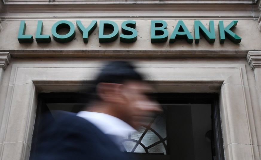 epa06112443 A pedestrian passes a Lloyds bank branch in London, Britain, 27 July 2017. Lloyds Banking Group’s has posted half-year profits ofn 2.5 billion pound, four percent more that 2016 and the la ...