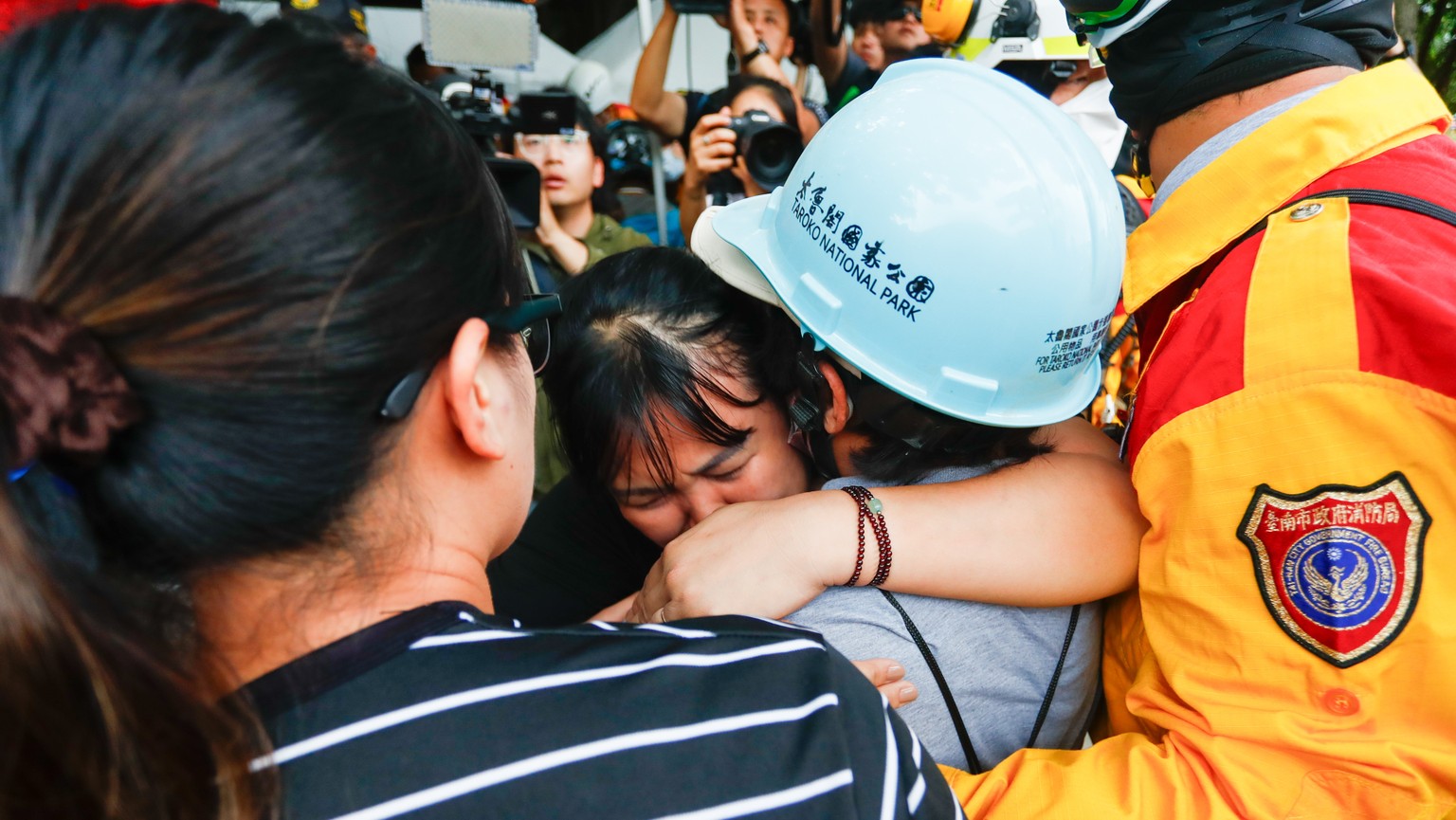 epaselect epa11259783 A woman bursts into tears while hugging her mother who was rescued to safety from the Tunnel of Nine Turns where she was trapped for more than two nights, following the 03 April  ...
