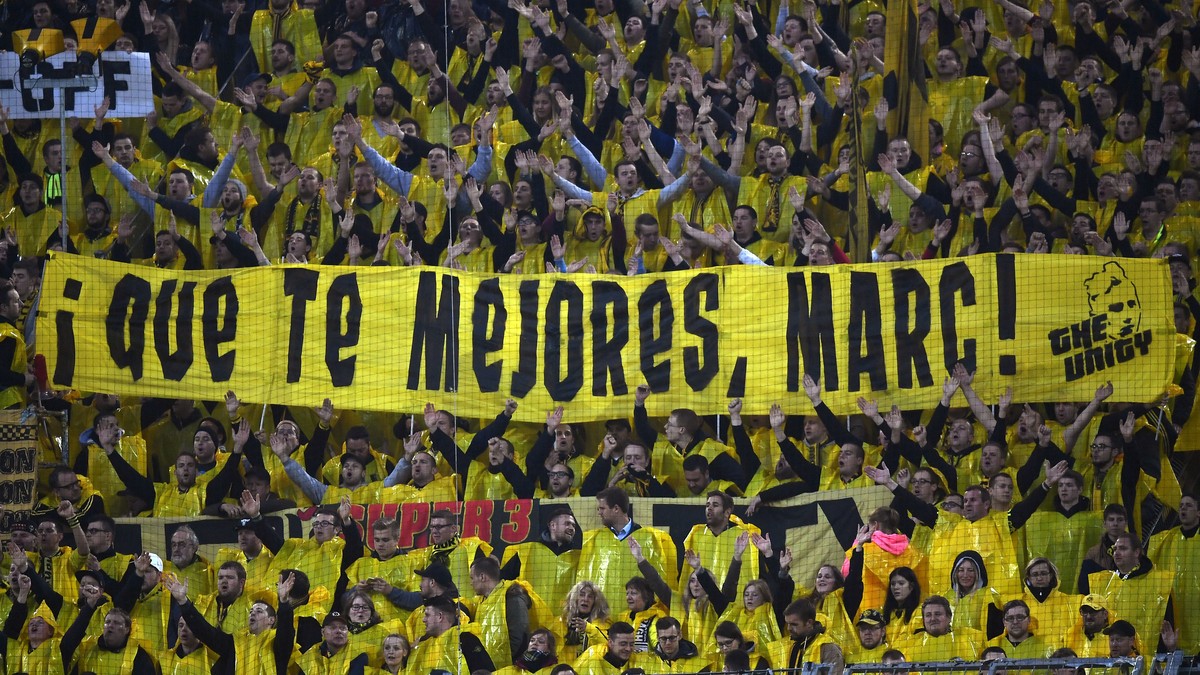 Dortmund fans hold a poster 'Get well, Marc!' during the Champions League quarterfinal first leg soccer match between Borussia Dortmund and AS Monaco in Dortmund, Germany, Wednesday, April 1 ...