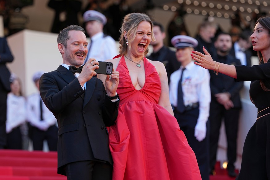 Elijah Wood, left, and Mette-Marie Kongsved take a photograph at the opening ceremony and premiere of the film 'The Electric Kiss' during 79th international film festival, Cannes, southern F ...