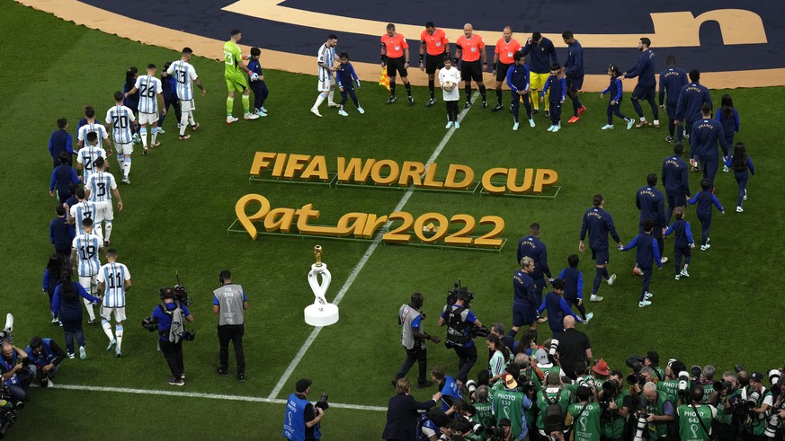 Players enter the pitch prior the World Cup final soccer match between Argentina and France at the Lusail Stadium in Lusail, Qatar, Sunday, Dec. 18, 2022. (AP Photo/Hassan Ammar)