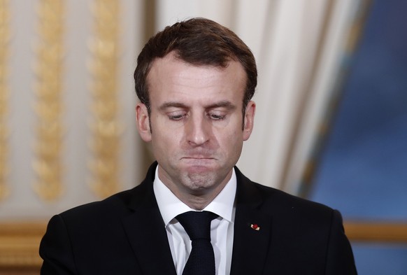 FILE - In this Monday, Dec. 17, 2018 file photo, French President Emmanuel Macron pauses before answering as he attends a media conference with Burkina Faso&#039;s President Roch Marc Christian Kabore ...