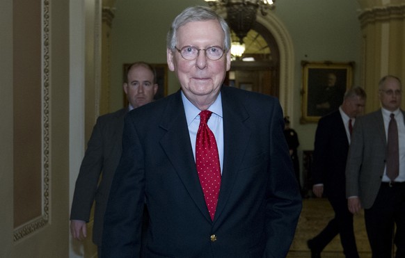 Senate Majority Leader Mitch McConnell, R-Ky., walks to his office after speaking on the senate floor Saturday, Jan. 20, 2018, at Capitol Hill in Washington. (AP Photo/Jose Luis Magana)