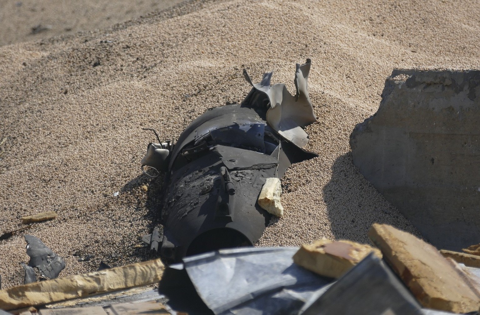 epa10760285 Part of an exploded rocket is seen near the damaged grain terminal of an agricultural farm in Odessa region, southern Ukraine, July 21, 2023. About 100 tons of peas and 20 tons of ...