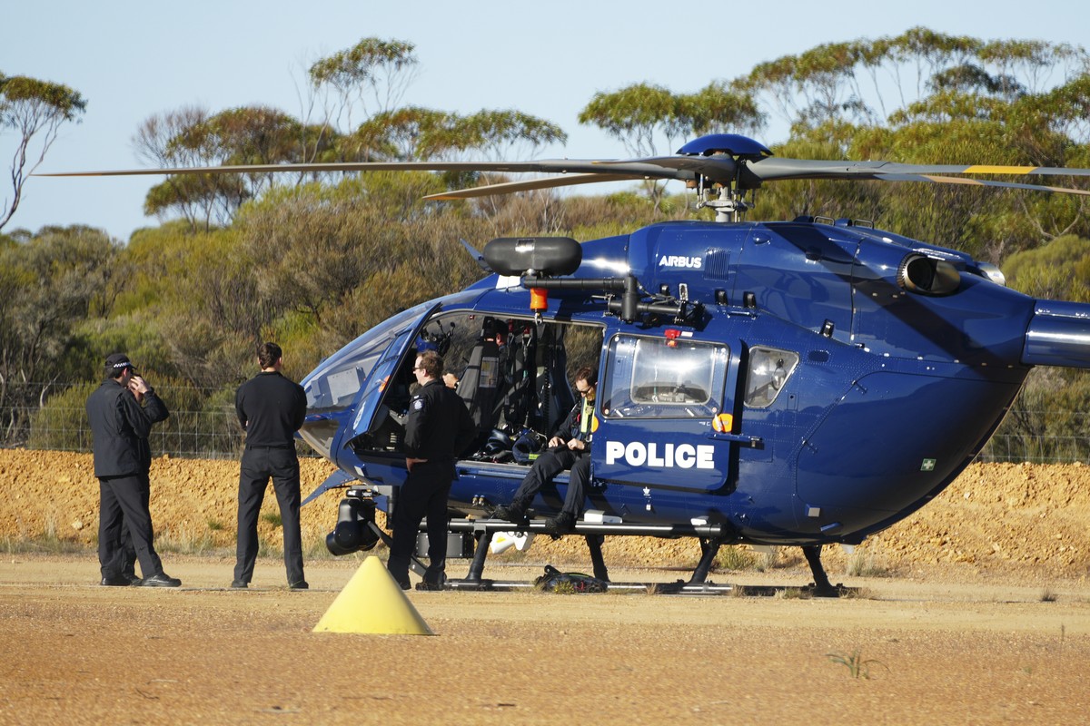 Police wait by a helicopter in Beacon, Western Australia, Friday, July 11, 2025, as they prepare to search for missing German backpacker Carolina Wilga. (ABC News via AP)
Australia German Backpacker