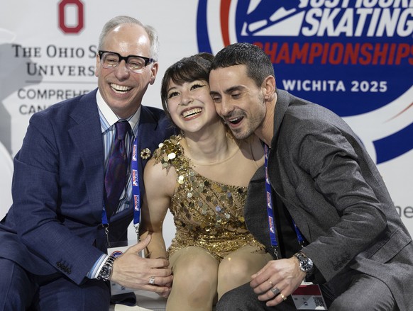 Alysa Liu, center, reacts with coaches Phillip Phillip DiGuglielmo, left, and Massimo Scali, right, after her performance during the women's free skate competition at the U.S. figure skating cham ...